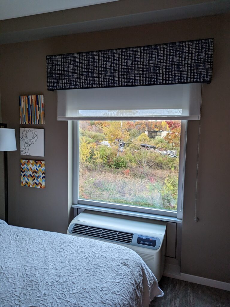View of fall leaves through a hotel window. 